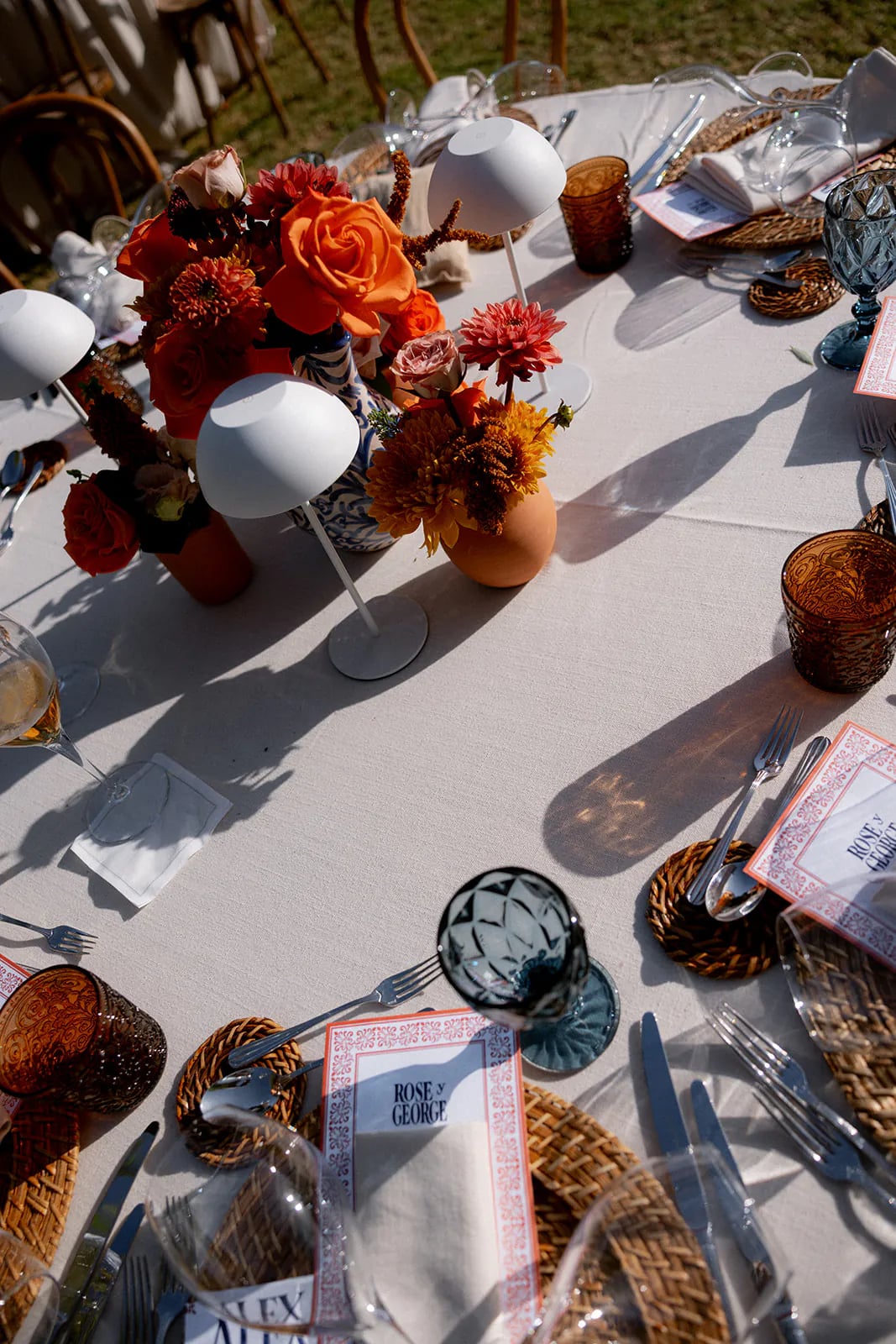 Orange floral centrepieces, blue ceramics and lamps